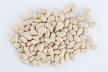 Closeup of raw navy beans under the lights isolated on a white background