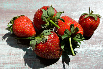 organic and fresh strawberries on a  wooden background