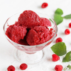 Sticker - homemade ice cream raspberry sorbet in kremanke and fresh raspberries on a light background. square format