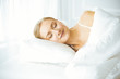 © Iryna - Beautiful young woman sleeping in bedroom comfortably and blissfully. Waking up in happy morning