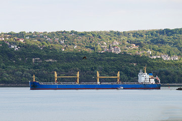 sea ​​cargo ship sailing along the shore
