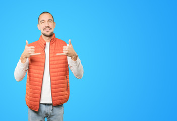 Happy young man making a gesture of calling with the hand