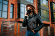 © Катя Іваськевич - young woman with mobile phone in the city in mask. coronavirus. covid-19.