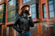© Катя Іваськевич - young woman with mobile phone in the city in mask. coronavirus. covid-19.