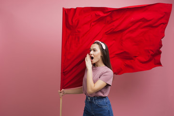 activist and revolutionary, young woman with a red flag on a pink background.