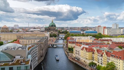 Wall Mural - Berlin, Germany, zoom out timelapse view of tour boats on the Spree River including historial landmark Berlin Cathedral and Museum Island.