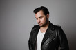 © face_reader_img - Portrait of modern young hipster man in a leather stylish jacket posing over a white background.