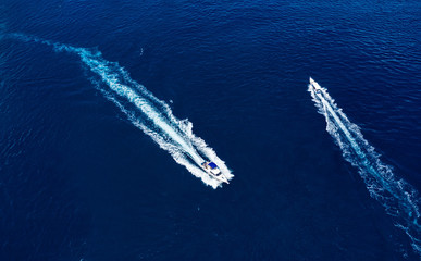 Wall Mural - yachts at the sea surface. aerial view of luxury floating boat on blue water at sunny day. top view 