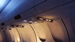 © fergregory - no smoking and fasten seatbelts signs inside an airplane, 3D rendering