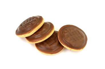 Wall Mural - Chocolate coated biscuit cakes with the orange filling isolated over the white background.