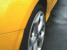 High Angle View Of Wet Yellow Car On Street
