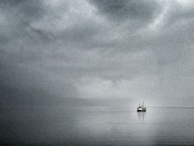 Lone Boat In Calm Sea Against The Sky