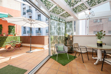 Terrace With White Metal Enclosure And Outdoor Umbrella