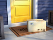 © Sashkin - Online purchase delivery service concept. Cardboard parcel box delivered outside the door. Parcel on the door mat near entrance door. 3d rendering