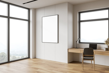 White and wooden home office corner with poster