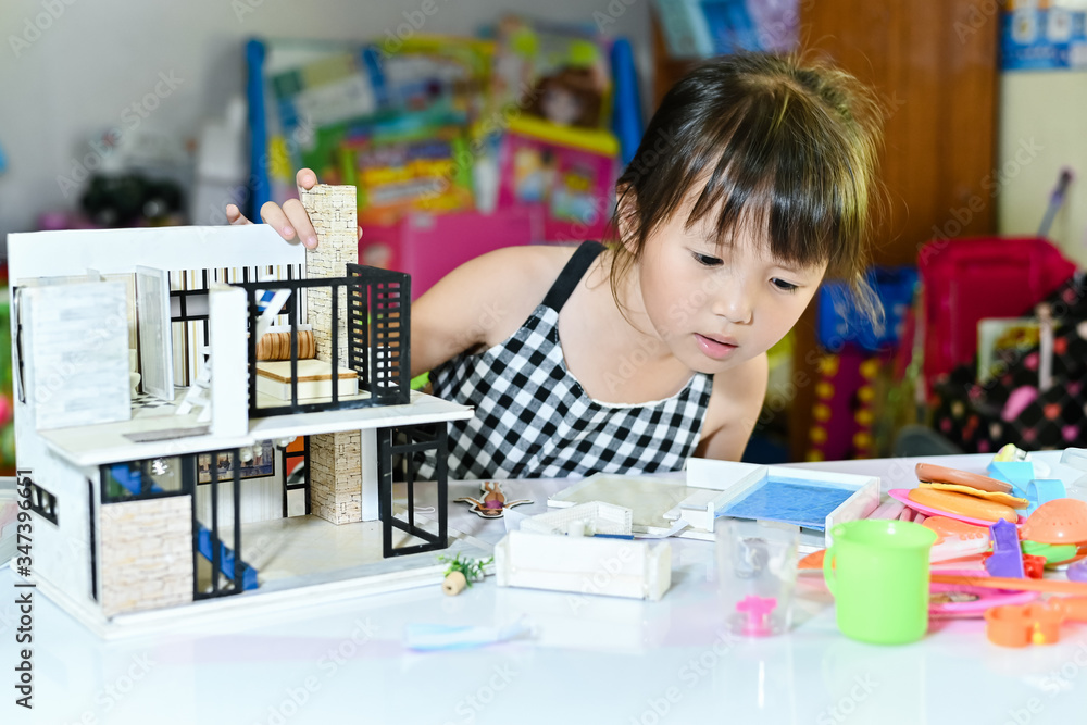 Asian little girl children playing at toy and leaning to enjoy the ...