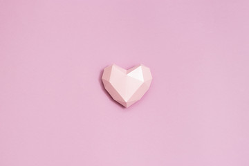 Poster - Pink polygonal paper heart shape on pink paper. Holiday background with copy space for Valentines Day. Love concept. Plain colored. Monochrome image. Minimal style.