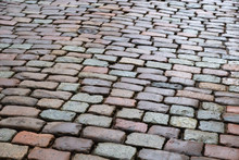 "Natural Paving Granite Stone On Road. Paving Stone In Old City. Wet Boulder.."