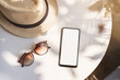 © Kittiphan - Empty screen smart phone with travel accessories on the table, Summer vacation concept