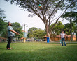 © ellinnur - Family of three playing ball in the Malaysia park.