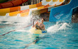 © Svetlana - Happy person has active summer vacation activities at the water park.