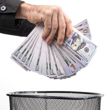 Close-up Of Men's Hands Throwing Money In The Trash
