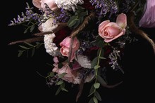 Closeup Shot Of A Luxurious Bouquet Of Pink Roses And White Flowers On A Black Background