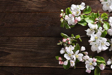 Wall Mural - spring background with apple blossom branches on wooden table