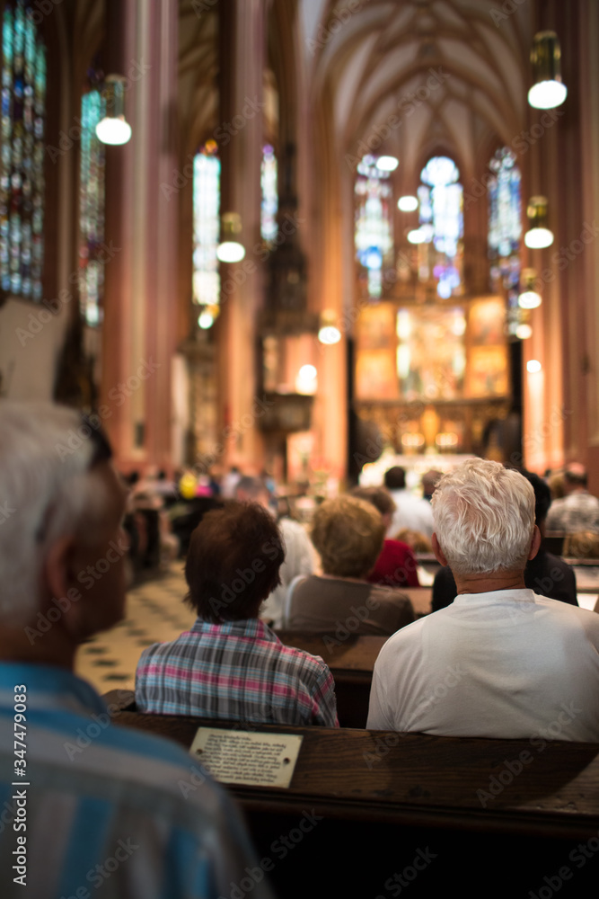 People in a church during a mass - obrazy, fototapety, plakaty 