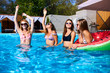 © artiemedvedev - Beautiful hot pretty girls in bikini have pool party dancing with inflatable watermelon swim ring floaty. Attractive slim women in swimsuits and sunglasses have fun relaxing on sunny summer day.
