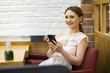 © michael spring - young woman sitting in a coffee shop with her phone
