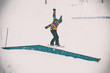 © guruXOX - Freerider snowboarder doing basic snowboard rails trick in freestyle snowpark. Winter mountain season