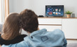 © Proxima Studio - Young couple watching TV on sofa