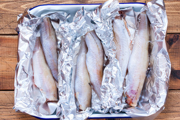 Step-by-step preparation of baked whole pollock in foil in the oven, step 2 - preparation of peeled fish carcasses, top view, selective focus