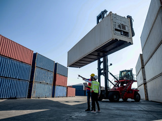 warehouse logistic cargo container  staff engineer and foreman harbor is pointing finger work import export business terminal shipping  crane forklift truck international industry