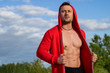 © A Stock Studio - Muscular man in a red jacket during outdoor sports training. Male power.