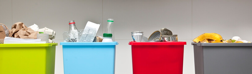 The four different container for sorting garbage. For plastic, paper, metal and organic waste