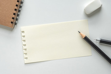 Wall Mural - close up. blank paper sheet with pencil, eraser and spiral notebook on white background. empty space