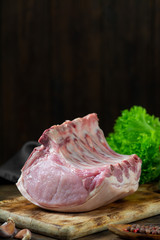 Wall Mural - Raw pork ribs on a wooden Board on a wooden background. Raw pork meat. Rustic style. With space for text