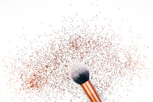 Makeup Brush And Golden Sparkles On White Background,
