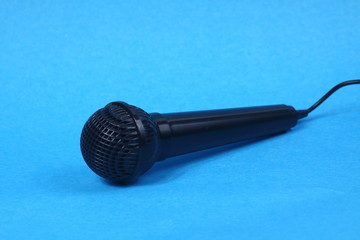 black microphone isolated on blue background