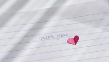 Miss You Note Hand Written On A Paper. Love Letter With Paper Heart. Relationship Concept. Distance Relationship Or Long Parting. Missing Love Or Partner. Romantic Reminder