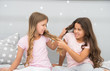 Unhand my hair. Naughty children pull on hair. Beauty look of little girls. Hair salon. Home clothing and leisure wear. Haidressing and styling. Because its my hair