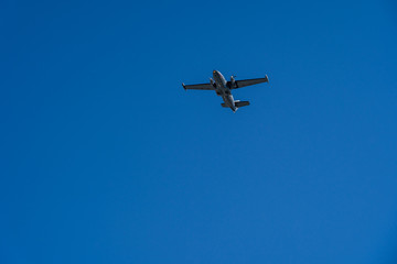 One aircraft of russian air forces is flying at airshow on bright blue sky