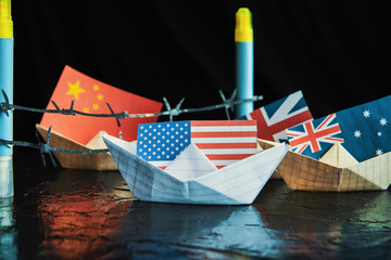 Wall Mural - paper ship with Flags of USA, Great Britain, Canada, Australia, Japan,EU and  China concept of conflict, shipment or free trade agreement 