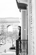 Attractive  yang woman in pajama is drinking coffee on balcony in the morning in city Paris. view of the triumphal arch.