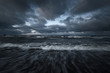 © Alex Stemmer - Storm clouds above the Baltic sea in winter, long exposure. Dramatic sky, waves and water splashes. Dark seascape. Germany