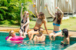 © yurakrasil - group of six friends having fun in swimmingpool outdoors
