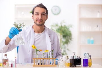 Young male chemist in perfume synthesis concept