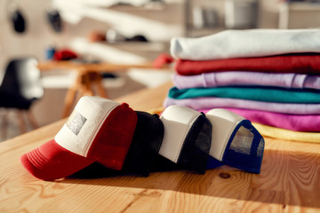 more than you expect. custom apparel, clothes neatly folded on shelves. stack of colorful clothing a